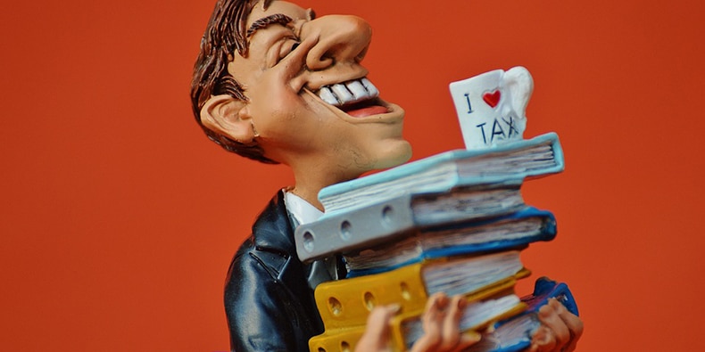 Accountant figurine holding stack of books and I