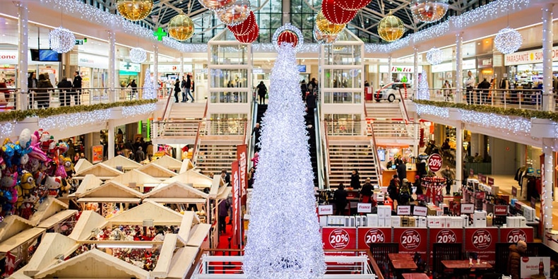 Busy shopping mall decorated for Christmas
