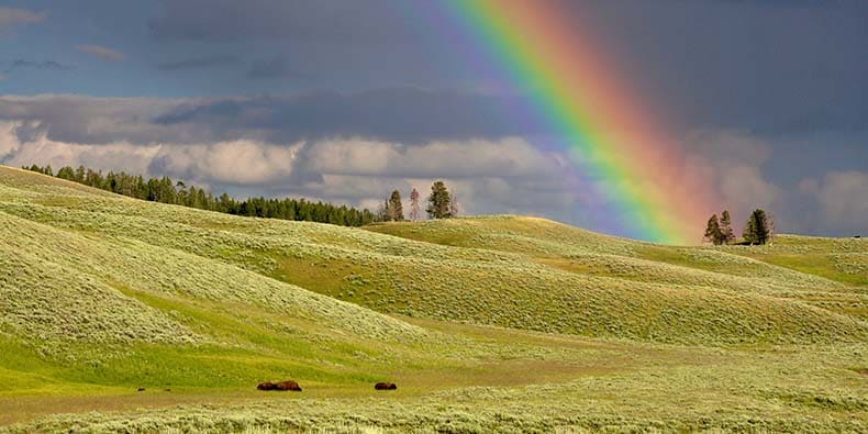 Rainbow over rolling hills