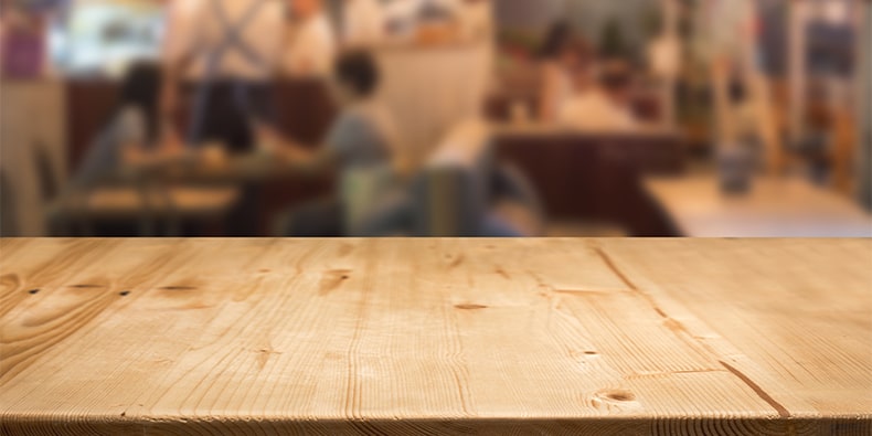 wood table counter with blurred food center for display food