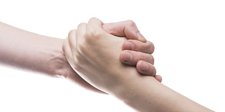 Two people holding hands; trusted advisor