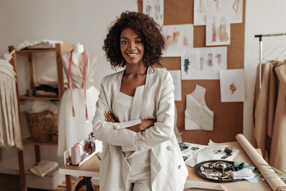 fashion-designer-poses-office-leans-table