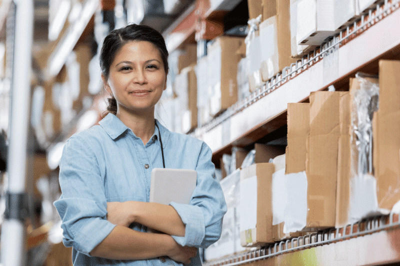 A young woman posing with an ipad while doing inventory | Financial Wake Up Call Business Link