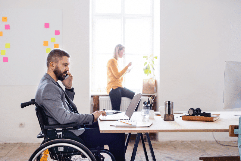 A young business man in a wheelchair prepping for a meeting | business link | business model canvas