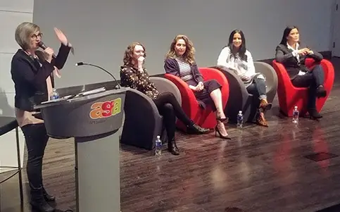 Moderator and panelists at women's event