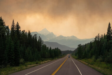 dramatic,landscape,with,smoke,clouds,along,a,highway,in,british