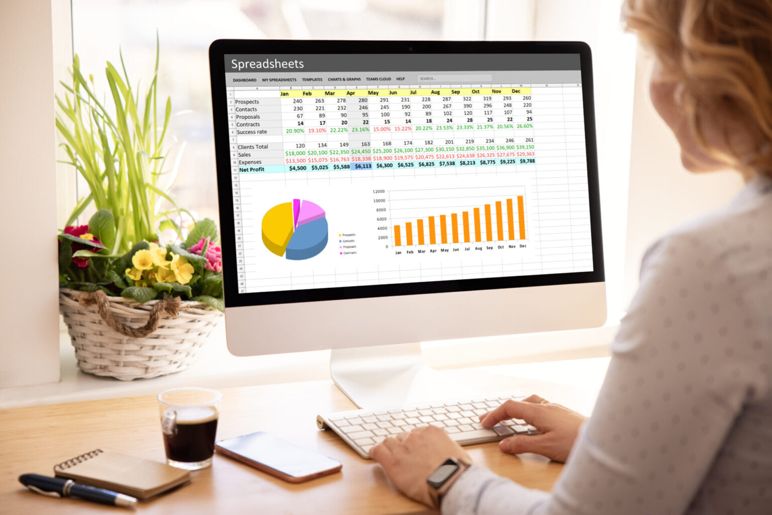 woman,working,with,spreadsheets,on,desktop,computer