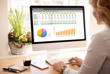 woman,working,with,spreadsheets,on,desktop,computer