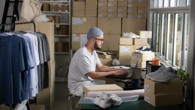 asian,man,online,seller,confirming,orders,from,customer,on,laptop.