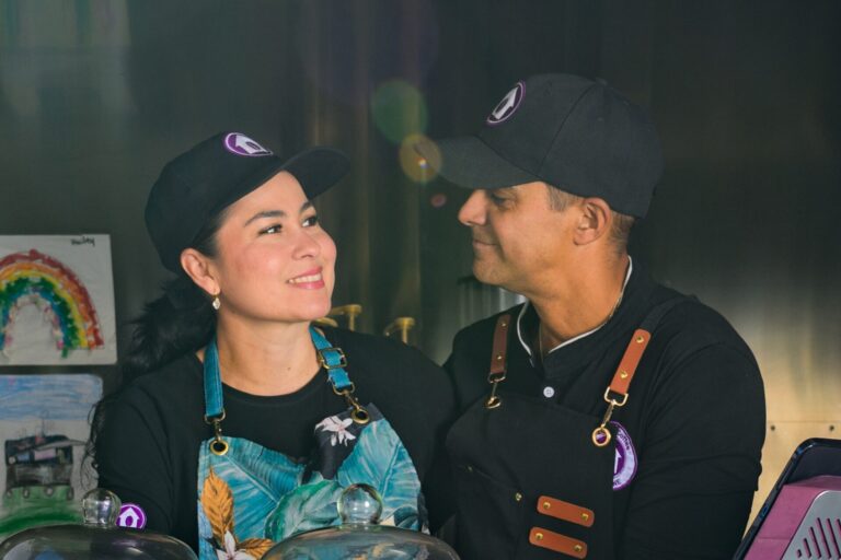 Martha and Luis of Colombian Harvest Coffee and Foods smiling at each other.